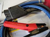 a red and black cable that is connected to a black and blue hose