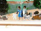 un tableau représentant deux personnes et un chien sur la plage