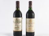 two bottles of wine sitting next to each other on a white surface