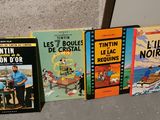 several books are lined up on a shelf in a room