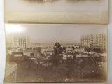 two old black and white photos of a city with buildings