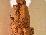 a statue of a woman holding a baby on a table