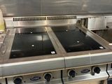 a large stainless steel stove top in a commercial kitchen