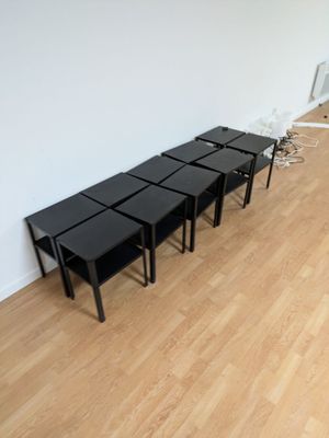 four black tables in a room with a white wall