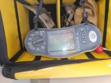 a digital multimeter in the back of a yellow boat