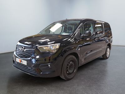 the black van is parked in a large room with a black floor