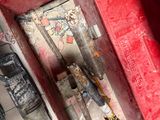 a red box with tools inside of it on the floor