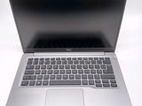 an open laptop computer sitting on top of a white table