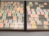 an open book with stamps on it sitting on a table