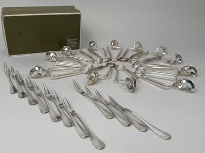 a lot of forks and spoons that are on the table