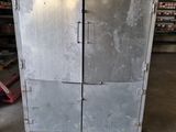 a metal cabinet in the middle of a warehouse