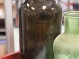two green vases on a table in a store