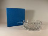 a glass bowl sitting on a table next to a blue box