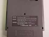 an old nintendo game is sitting on a white surface