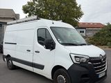 the white van is parked in the parking lot outside of the building