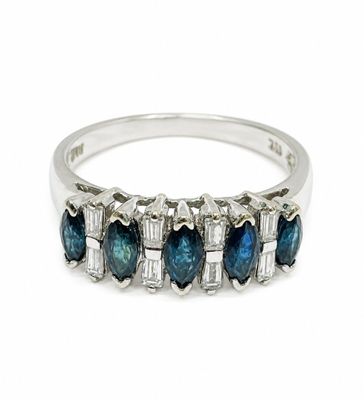 a close up of a ring with blue and white diamonds