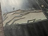 a picture of a metal table with a mountain design on it
