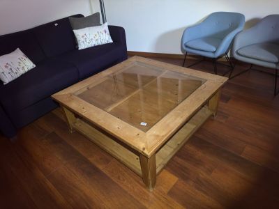a coffee table with a glass top in a living room