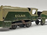 a green and yellow toy train on a white surface
