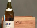 une bouteille de vin posée à côté d'une caisse en bois