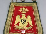an image of a red and gold badge with a crown on it