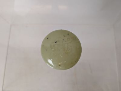 a small green object in the middle of a white box