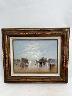 an oil painting of a cityscape in a gold frame on a white wall