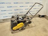 a close up of a small lawn mower with a yellow handle