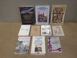 several books are sitting on a table in front of a wall