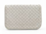 the white clutch bag has a woven design on the front and sides