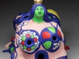 ceramic figurine of a woman with a crown on her head