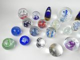 many different colored glass marbles on a white surface