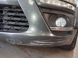 a close up of the front of a car with a denting on it