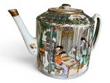 a teapot with a painting on it sitting on a table