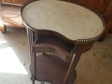 a small table with a tray on it in the middle of a room