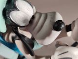 a figurine of a mickey mouse holding a toothbrush