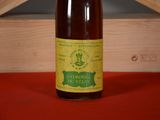 a bottle of wine sitting on a table next to a wooden box