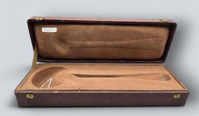 a brown case with a pair of scissors inside of it