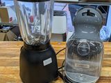 two blenders sitting on a wooden table in a store