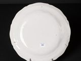 an image of a white plate sitting on top of a black table