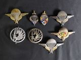 six different military badges on a black background