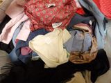 a pile of clothes that is sitting on the floor