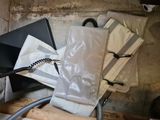 a pile of bags and a laptop computer on a table