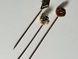 three different types of knitting needles on a white surface