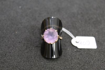 purple amethorate ring on a black surface with a price tag
