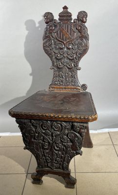 a wooden chair that is sitting on a tile floor