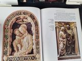 an open book with a picture of a woman holding a child and a picture of a man holding a child