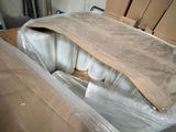 a bed that has been wrapped up and is sitting in the middle of a room