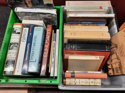 many books in a green box on a table