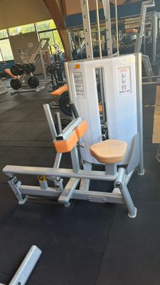 a gym room with machines and other equipment in it